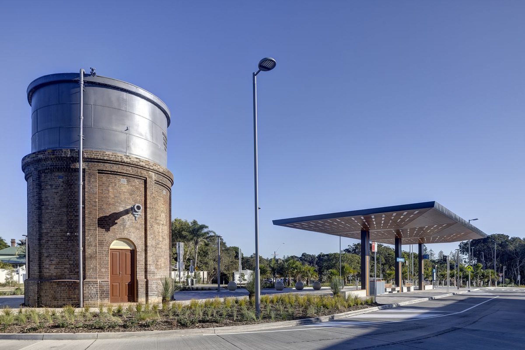 A converted heritage water tower alongside a contemporary steel and timber canopy structure